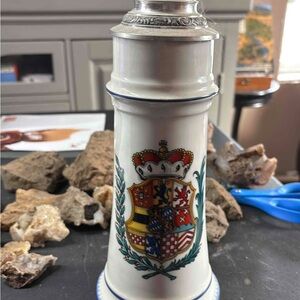 A German ceramic beer stein with a pewter lid and coat of arms, by Kurt Hammer